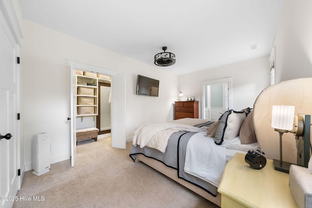 bedroom featuring light carpet and baseboards