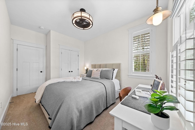 bedroom with baseboards and carpet
