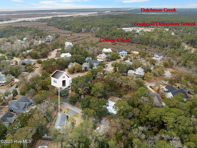 aerial view featuring a residential view and a wooded view