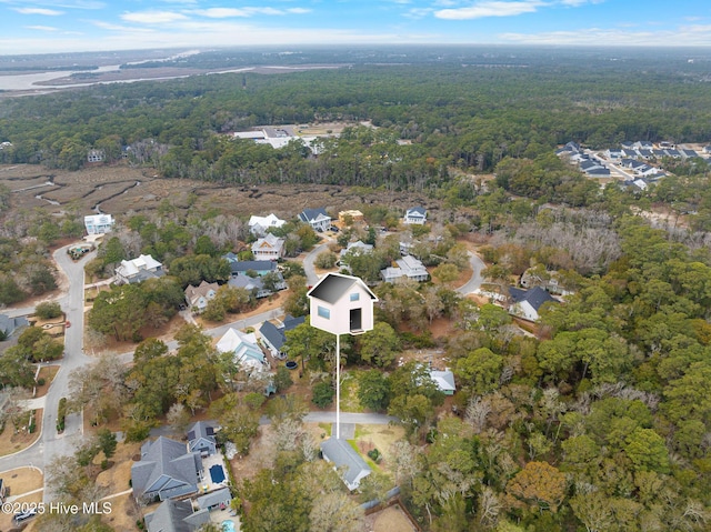 birds eye view of property featuring a forest view and a residential view