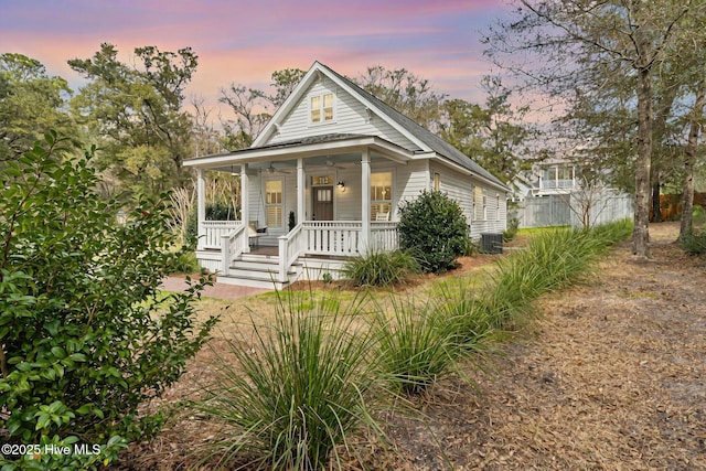 view of front facade with a porch and central AC unit