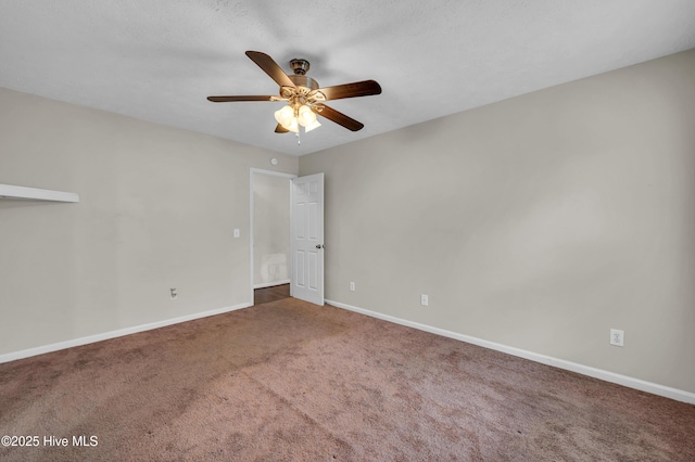 empty room featuring carpet flooring, a ceiling fan, and baseboards