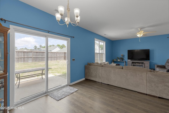 living area featuring a chandelier, wood finished floors, and a ceiling fan