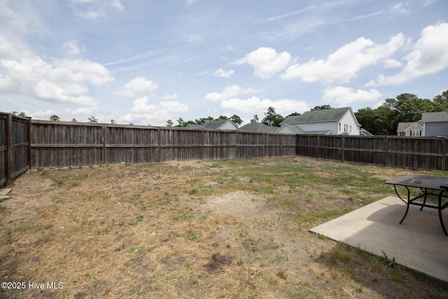 fenced backyard with a patio area