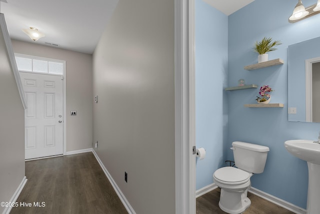 foyer with wood finished floors and baseboards