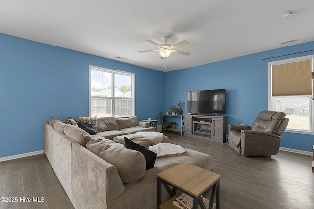 living room with a ceiling fan, wood finished floors, and baseboards