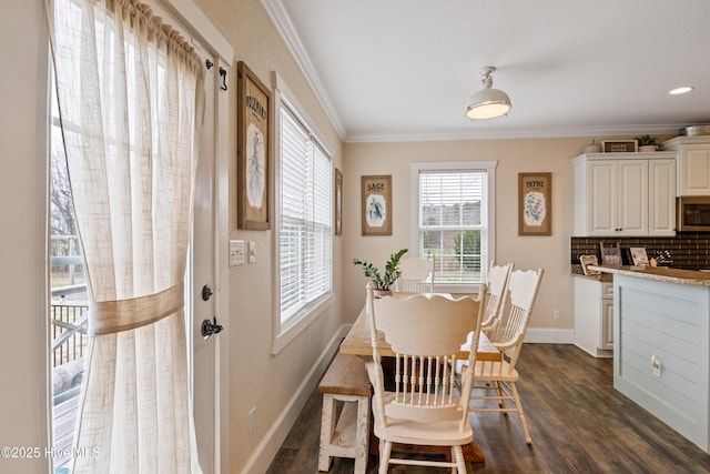 dining area with baseboards, ornamental molding, and dark wood-style floors
