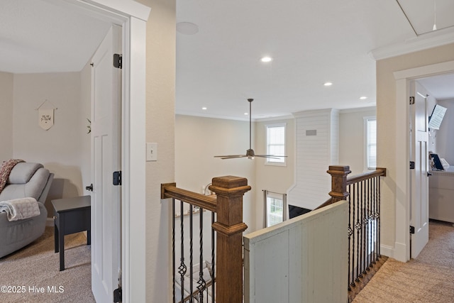 hall with recessed lighting, an upstairs landing, crown molding, attic access, and carpet flooring