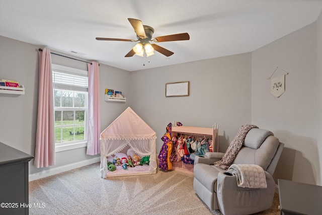 rec room with carpet, visible vents, a ceiling fan, and baseboards