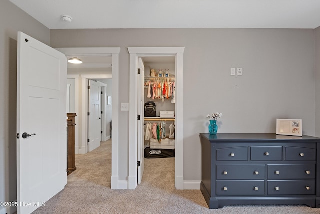 hall with light carpet and baseboards