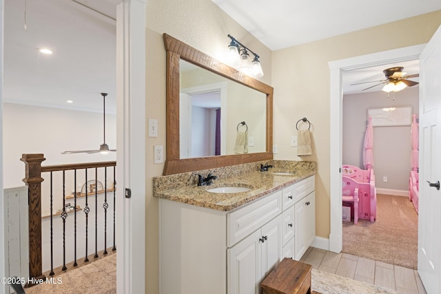 bathroom with a ceiling fan, a sink, and double vanity