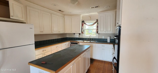 6693 NC-92, Bath, NC 27808 - kitchen with a sink, visible vents, dark countertops, and freestanding refrigerator