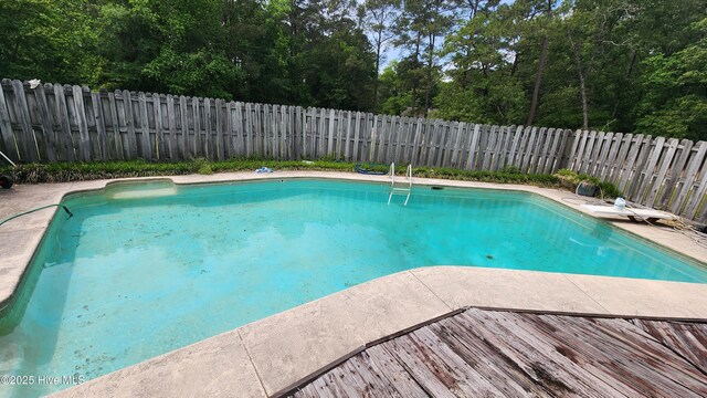 view of swimming pool featuring a fenced backyard and a fenced in pool
