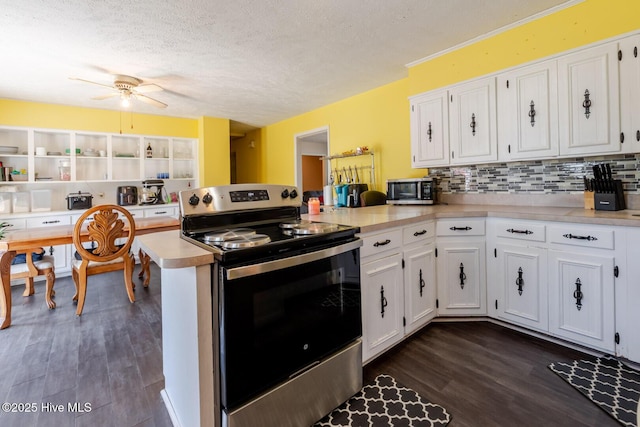 kitchen featuring appliances with stainless steel finishes, a peninsula, and white cabinets