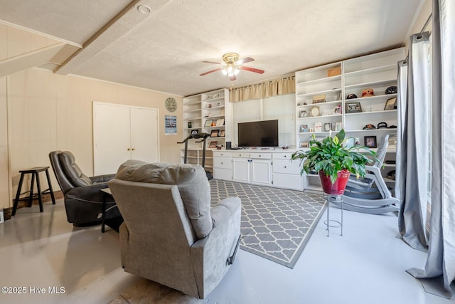 living area featuring ceiling fan and concrete floors