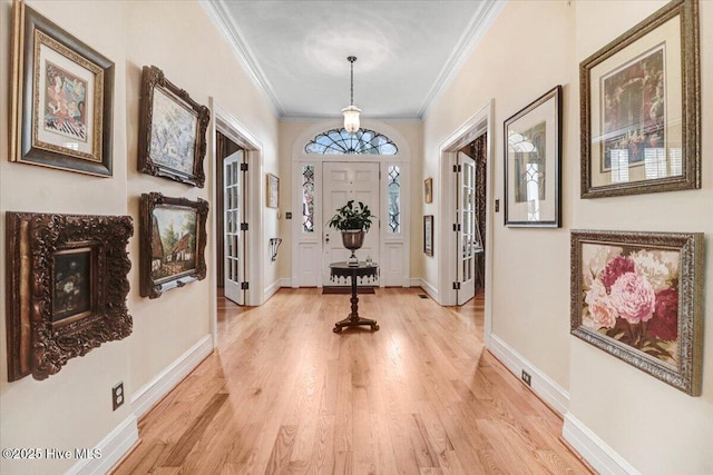 705 Park Ave, Goldsboro, NC 27530 - entrance foyer with baseboards, light wood finished floors, and ornamental molding
