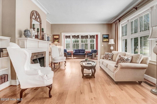 705 Park Ave, Goldsboro, NC 27530 - living room featuring a fireplace, crown molding, light wood-style floors, and baseboards