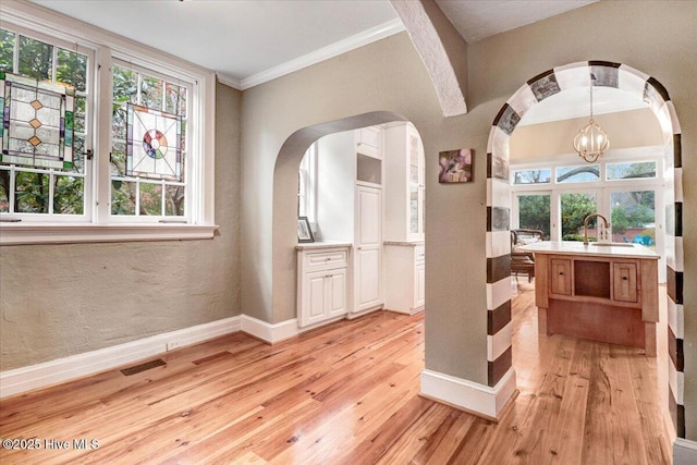 705 Park Ave, Goldsboro, NC 27530 - interior space featuring arched walkways, light wood finished floors, and baseboards