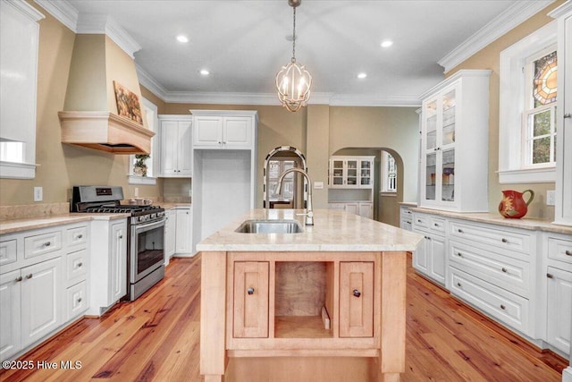 705 Park Ave, Goldsboro, NC 27530 - kitchen featuring a sink, white cabinetry, arched walkways, stainless steel range with gas cooktop, and glass insert cabinets