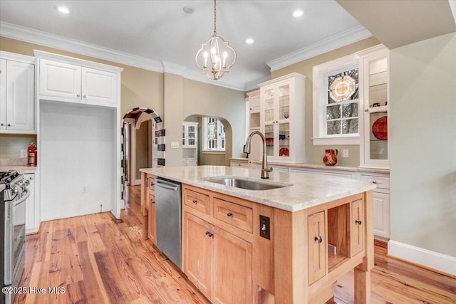 705 Park Ave, Goldsboro, NC 27530 - kitchen with a sink, light wood-style floors, arched walkways, stainless steel appliances, and a kitchen island with sink
