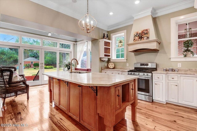 705 Park Ave, Goldsboro, NC 27530 - kitchen featuring open shelves, a sink, stainless steel gas stove, crown molding, and light wood-type flooring
