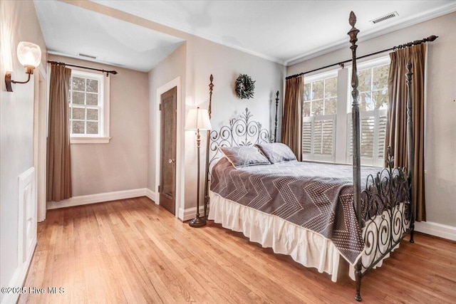 705 Park Ave, Goldsboro, NC 27530 - bedroom featuring visible vents, multiple windows, light wood-style floors, and baseboards