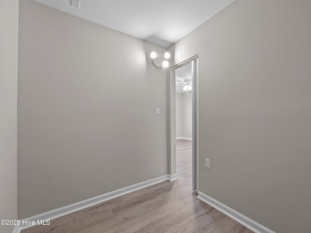 empty room with baseboards, a ceiling fan, and wood finished floors