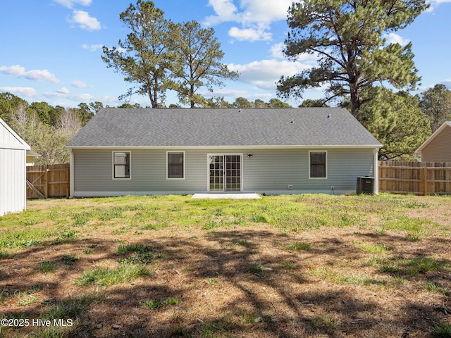 back of house featuring a yard, fence, and cooling unit