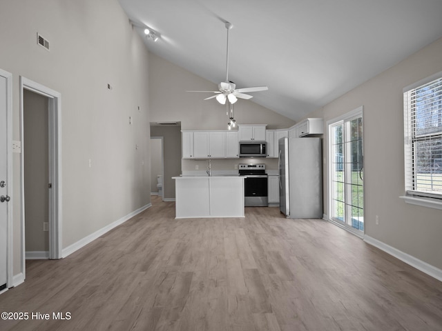 kitchen with visible vents, open floor plan, ceiling fan, light countertops, and stainless steel appliances