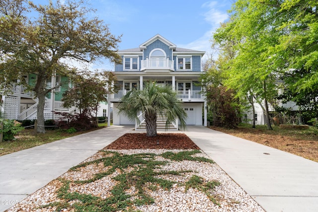 604 Fourth St S, Carolina Beach, NC 28428 - raised beach house featuring driveway, stairway, a garage, and covered porch