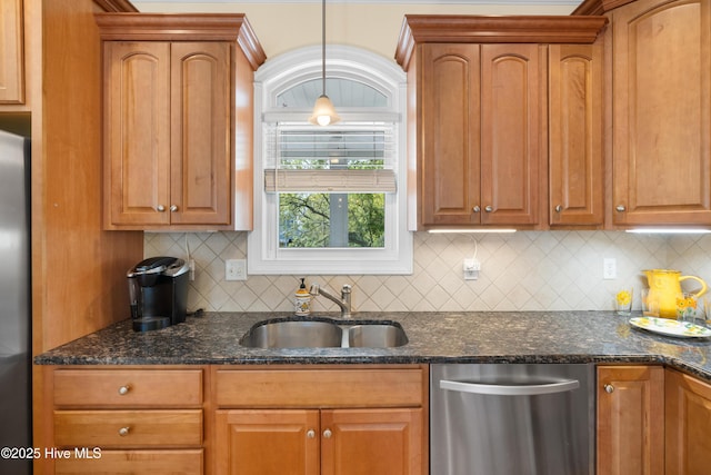 604 Fourth St S, Carolina Beach, NC 28428 - kitchen with stainless steel appliances, decorative backsplash, dark stone countertops, and decorative light fixtures