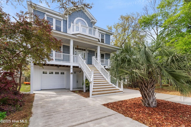 604 Fourth St S, Carolina Beach, NC 28428 - coastal inspired home with covered porch, stairs, an attached garage, a balcony, and concrete driveway