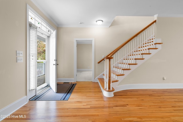 604 Fourth St S, Carolina Beach, NC 28428 - entryway with wood finished floors, stairs, and ornamental molding