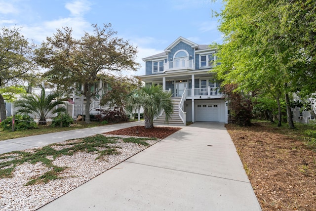 604 Fourth St S, Carolina Beach, NC 28428 - coastal home with stairs, concrete driveway, a porch, and a garage