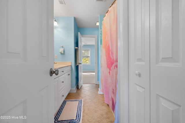 604 Fourth St S, Carolina Beach, NC 28428 - bathroom with vanity, tile patterned flooring, and a closet