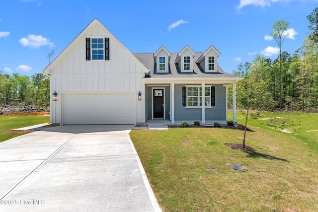 1007 Tawney Trce, New Bern, NC 28562 - view of front of home with board and batten siding, driveway, a front yard, covered porch, and a shingled roof