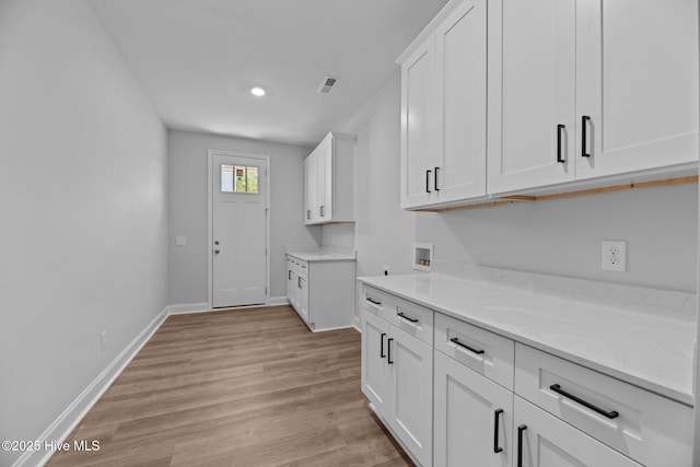 1007 Tawney Trce, New Bern, NC 28562 - kitchen with white cabinetry, light wood-type flooring, baseboards, and recessed lighting