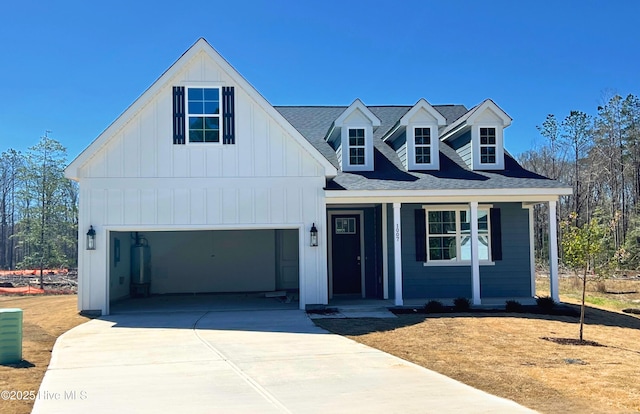 1007 Tawney Trce, New Bern, NC 28562 - modern farmhouse with board and batten siding, covered porch, driveway, a garage, and a shingled roof