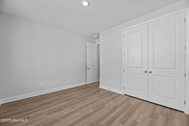 1007 Tawney Trce, New Bern, NC 28562 - unfurnished bedroom featuring wood finished floors, a closet, baseboards, and recessed lighting
