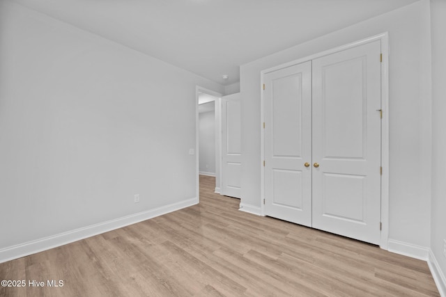 1007 Tawney Trce, New Bern, NC 28562 - unfurnished bedroom with light wood finished floors, baseboards, and a closet