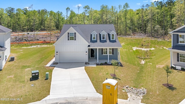 1007 Tawney Trce, New Bern, NC 28562 - traditional-style house featuring board and batten siding, concrete driveway, a porch, an attached garage, and a front yard