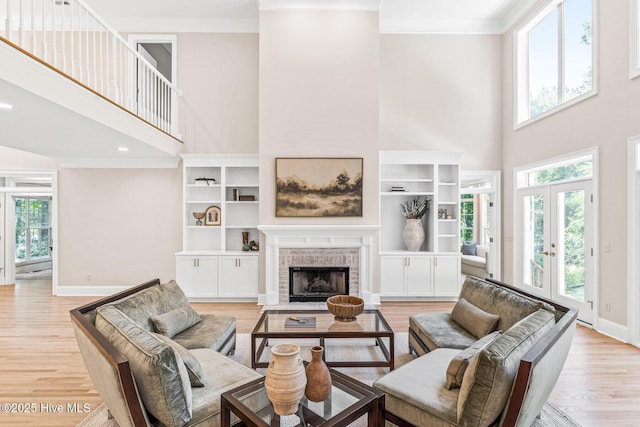 6932 Runningbrook Ter, Wilmington, NC 28411 - living area featuring a high ceiling, plenty of natural light, crown molding, light wood-style flooring, and french doors