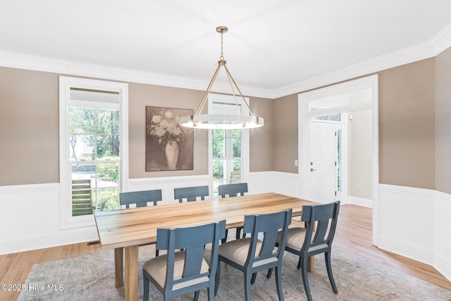 6932 Runningbrook Ter, Wilmington, NC 28411 - dining space with plenty of natural light, wainscoting, wood finished floors, and crown molding