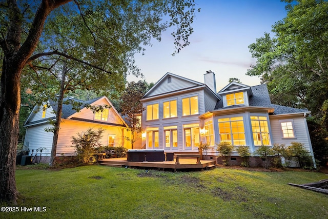 6932 Runningbrook Ter, Wilmington, NC 28411 - back of property at dusk with a deck, a lawn, a chimney, crawl space, and a shingled roof