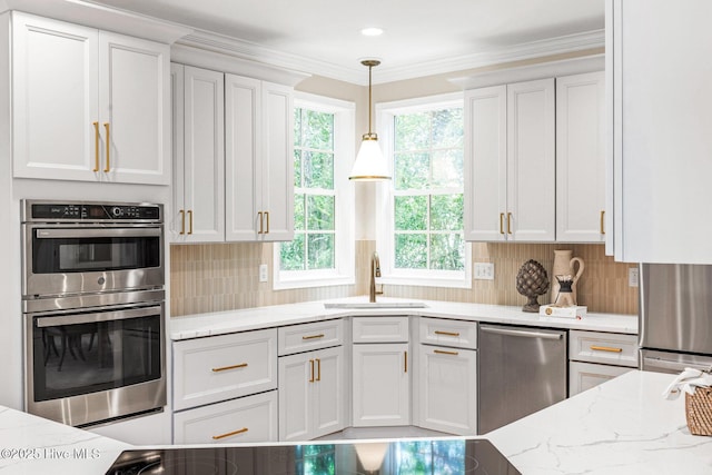 6932 Runningbrook Ter, Wilmington, NC 28411 - kitchen with stainless steel appliances, healthy amount of natural light, white cabinetry, and crown molding