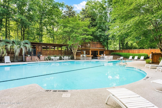 6932 Runningbrook Ter, Wilmington, NC 28411 - community pool with a patio area and view of wooded area