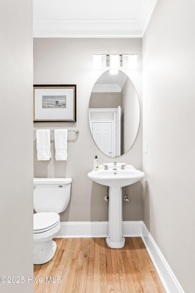 6932 Runningbrook Ter, Wilmington, NC 28411 - half bathroom featuring hardwood / wood-style flooring and crown molding