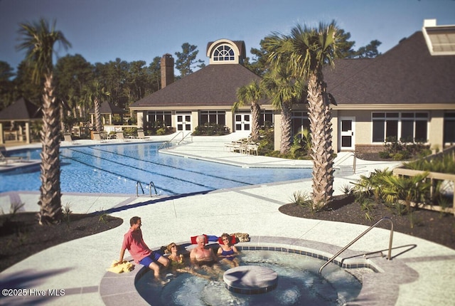 pool featuring a patio and a hot tub