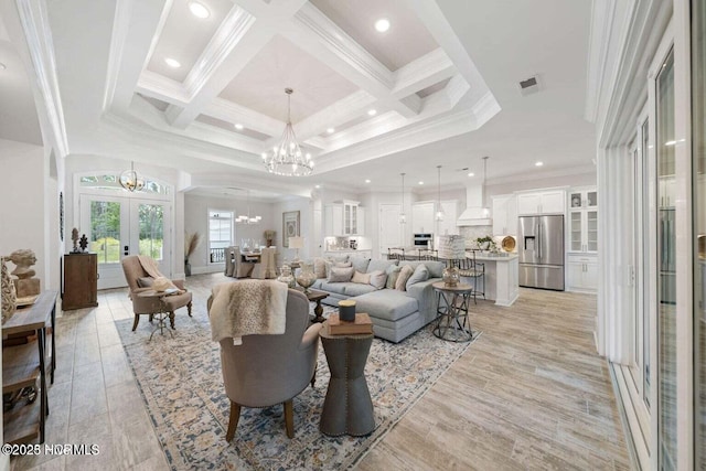 living area featuring visible vents, a notable chandelier, crown molding, french doors, and coffered ceiling