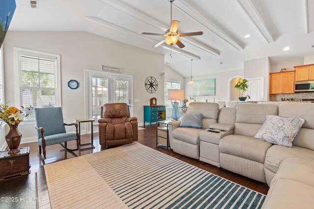 dining space with wood finished floors, a decorative wall, vaulted ceiling, and a wainscoted wall